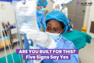 Surgeon in blue scrubs and cap in a bright operating room, AUSCARE International College logo in the top right with bold purple banner text reading “Are You Built For This? Five Signs Say Yes.”