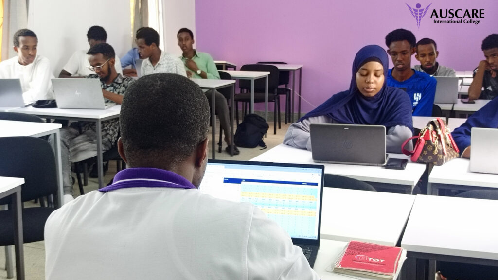 Classroom scene with students using laptops, a purple wall, and the AUSCARE International College logo in the corner.
