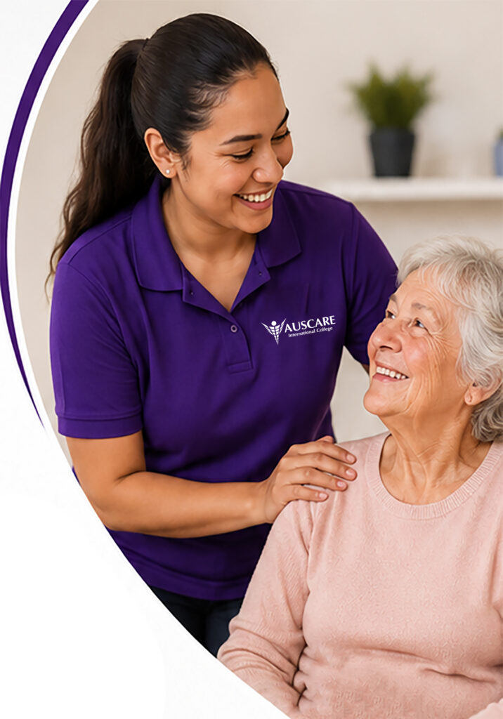 Caregiver in a purple polo with AUSCARE logo comforting and smiling at an elderly woman.